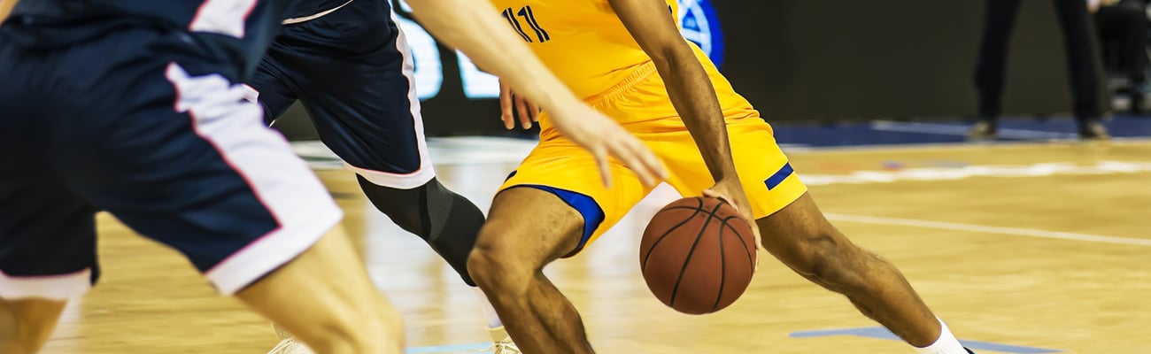 The basketball ball is on the basketball player's hand; Shutterstock ID 1475786261