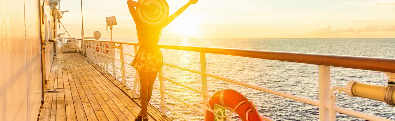 Luxury cruise ship travel elegant woman having fun carefree on deck enjoying watching sunset on Europe cruising destination vacation. Summer european mediterranean cruiseship sailing away on holiday.; Shutterstock ID 1551356090