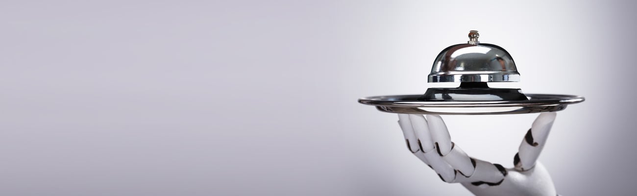 Robotic Hand Holding Bell On Silver Plate Against Grey Background; Shutterstock ID 1588830865