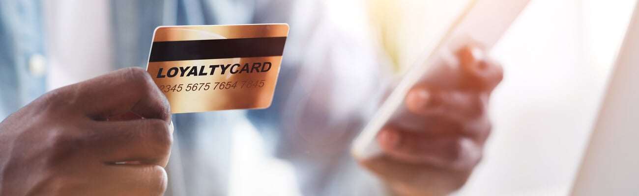 Collage with African American guy holding loyalty card while doing online shopping at home, close up. Panorama; Shutterstock ID 1720388020