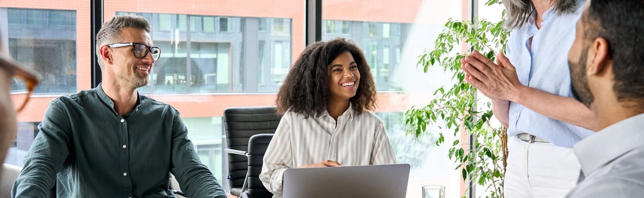 Senior older female executive ceo and happy multicultural business people discuss corporate project at boardroom table. Smiling diverse corporate team working together in modern meeting room office.; Shutterstock ID 2024994269