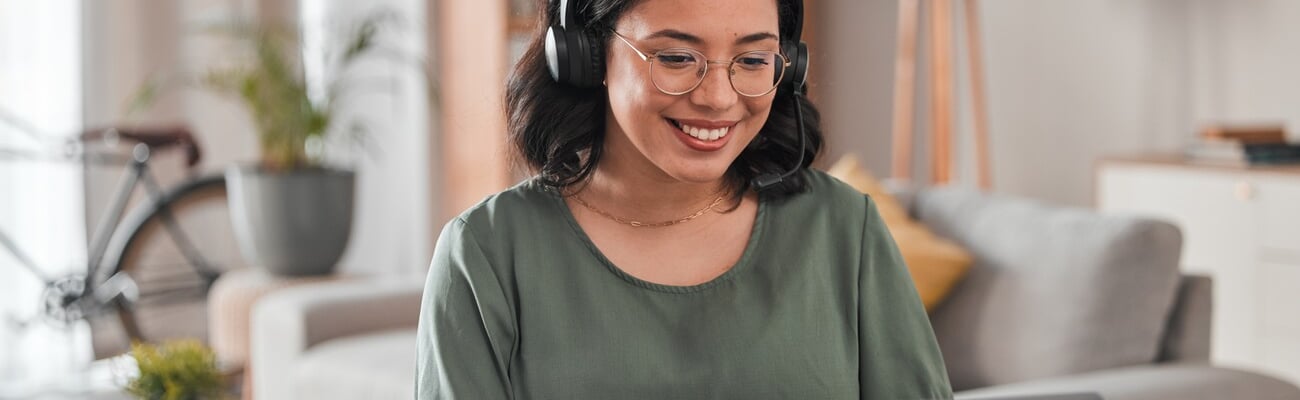 Happy, remote work and woman with a laptop for call center communication and consultation. Smile, virtual assistant and a customer service agent typing on a computer from a house for telemarketing; Shutterstock ID 2337392717