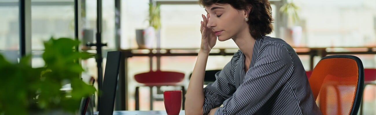 European Caucasian business woman sitting chair feel tired lack of energy indoor job office work place. Young adult gen z exhausted lazy bored female worker lady employee use laptop do over hours work; Shutterstock ID 2471883261