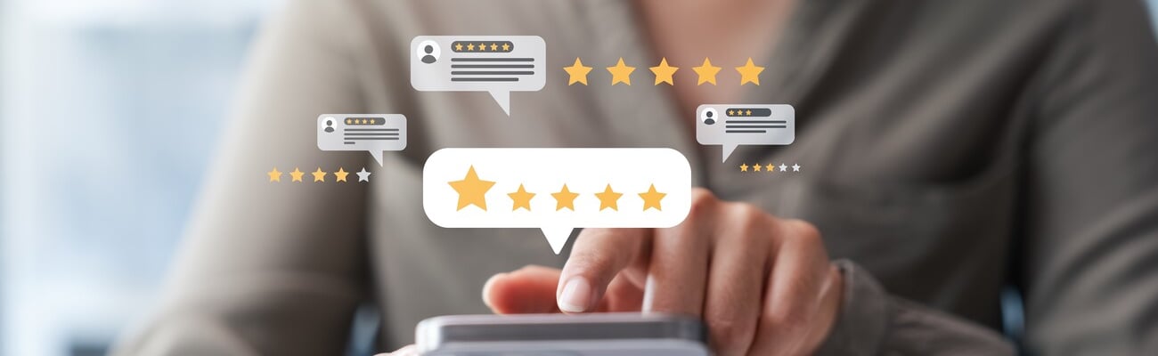 Female customers evaluate the quality of products and services, giving a maximum rating of 5 stars through an online application to gather experience data.; Shutterstock ID 2492412217