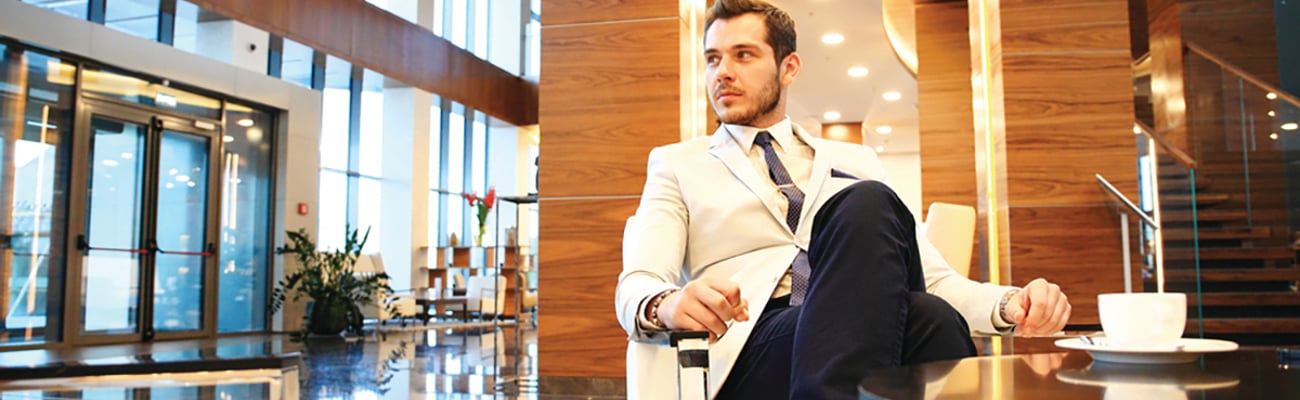 man sitting in hotel lobby