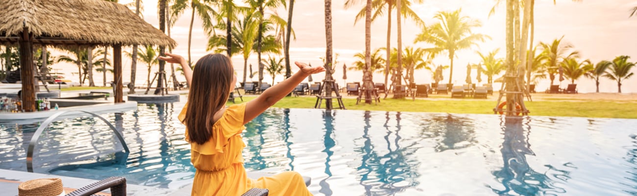 woman in a yellow dress by a pool