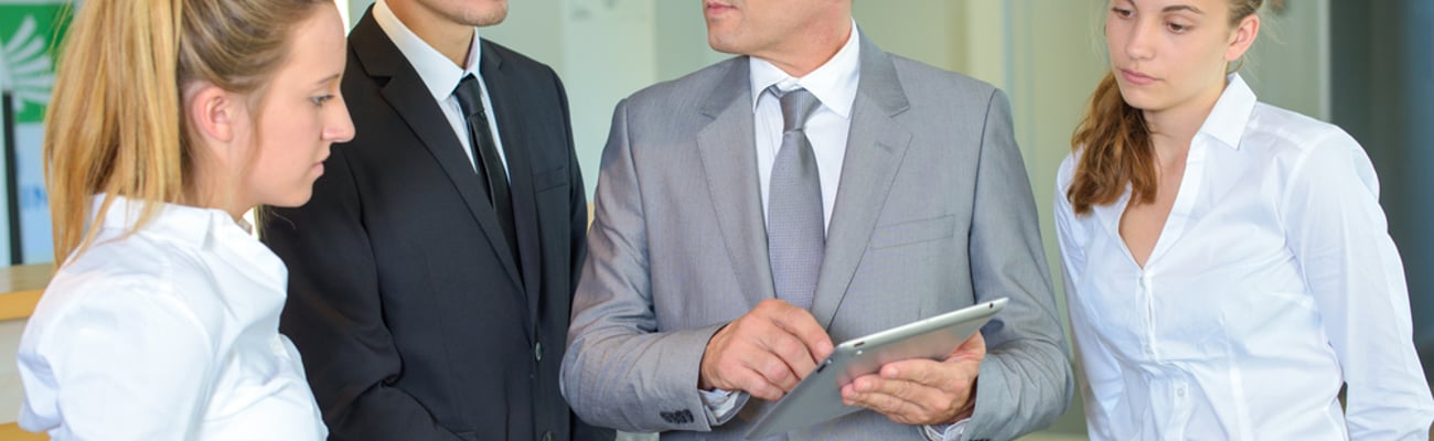 hotel team members looking at a tablet