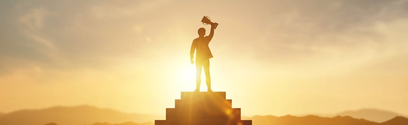 Businessman holding trophy