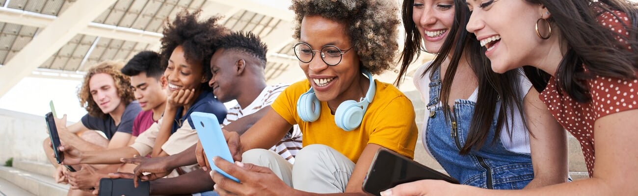 Group of young mixed race people with mobile phones. Excited students using their technological devices. Concept of young enterprising, friendly, selfie, app, hipster, millennial.; Shutterstock ID 2146917703