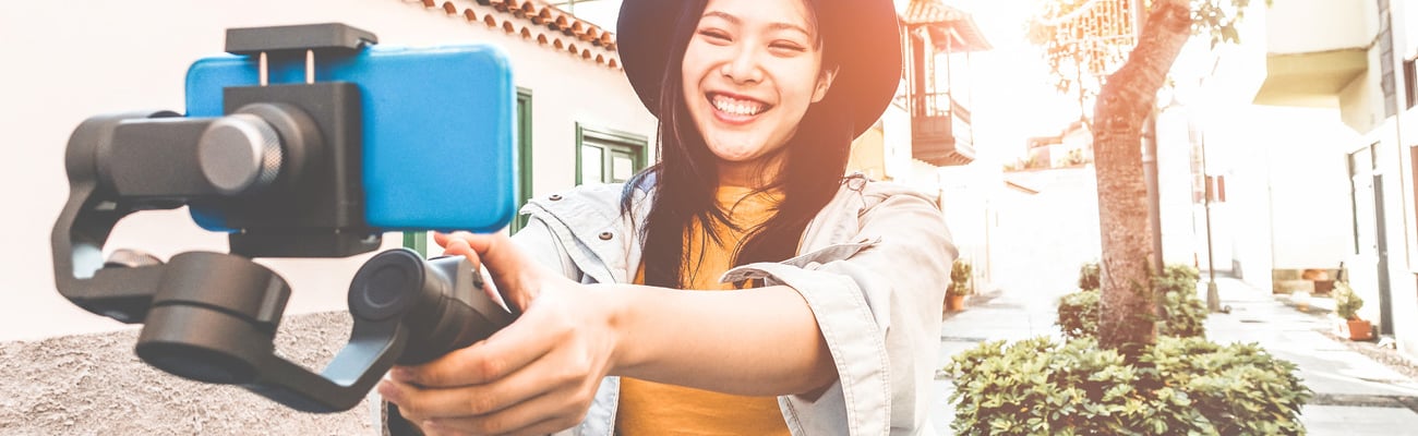 Happy asian woman vlogging with gimbal tripod and smartphone - Influencer chinese girl having fun with new trend technology - Millennial generation activity job, youth and tech concept - Focus on face; Shutterstock ID 1290378877