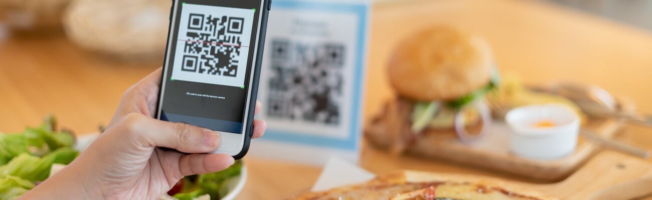 Woman use smartphone to scan QR code to pay in cafe restaurant with a digital payment without cash. Choose menu and order accumulate discount. E wallet, technology, pay online, credit card, bank app.; Shutterstock ID 2295070737