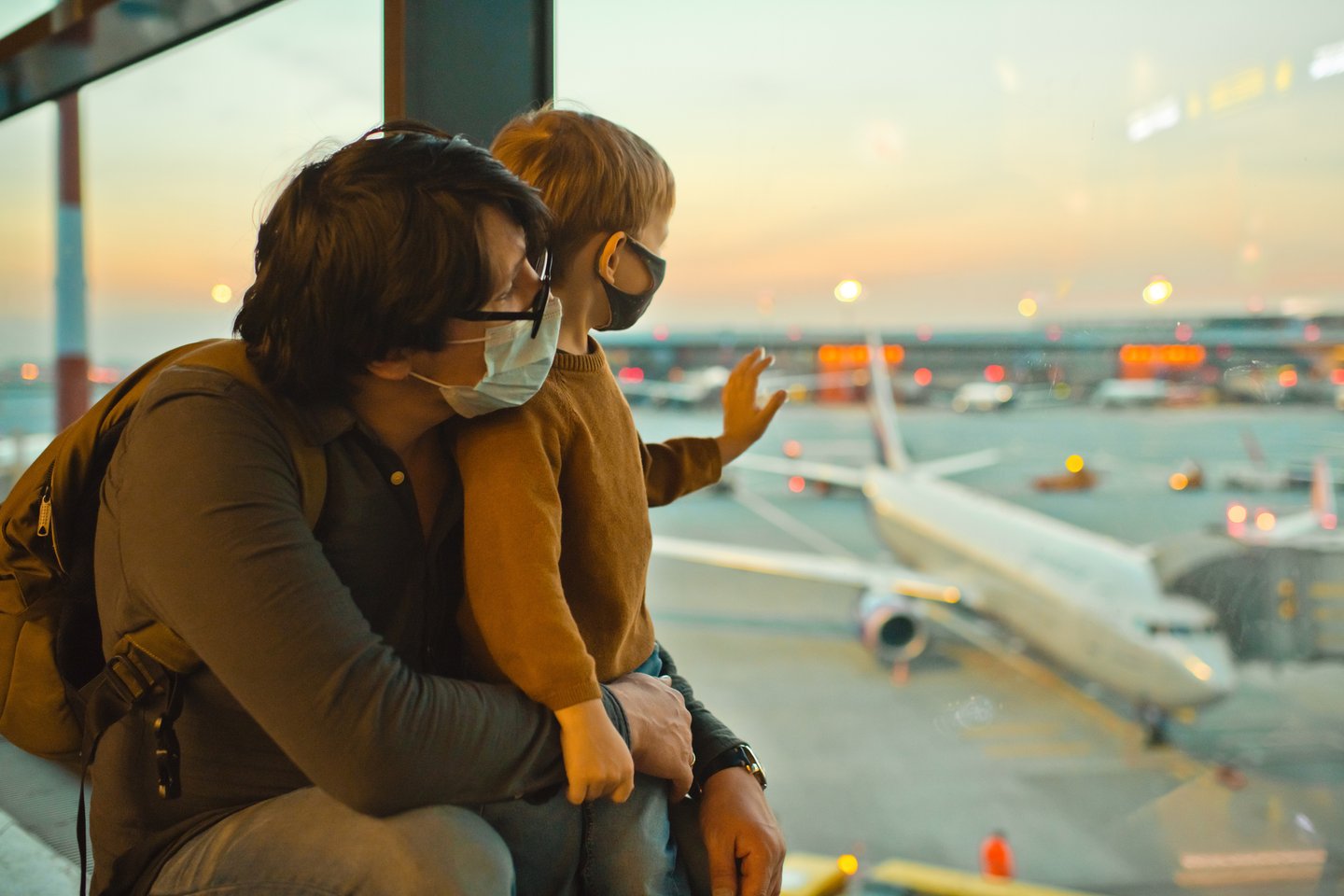 a woman sitting on a tarmac at an airport