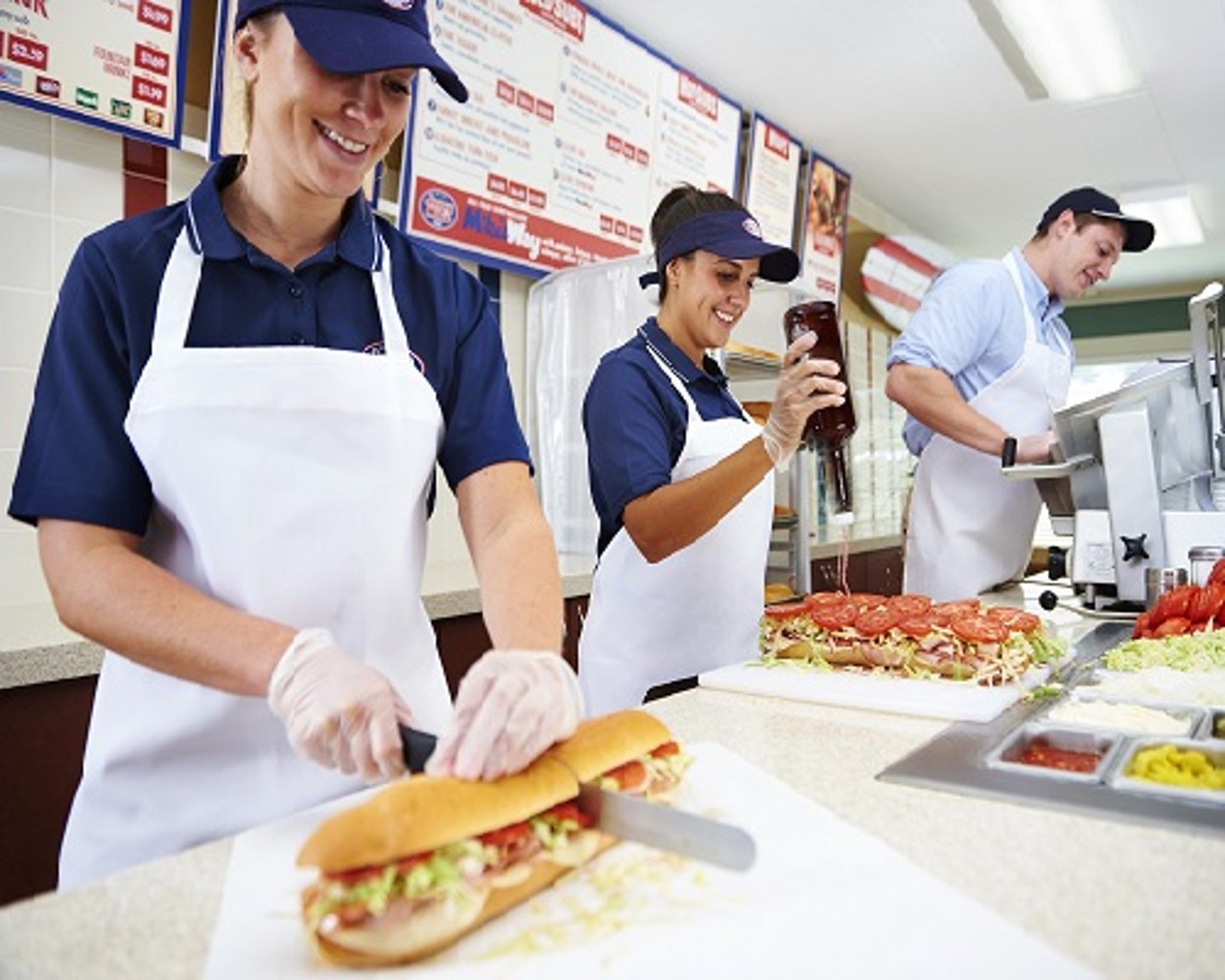 a group of people preparing food on a table