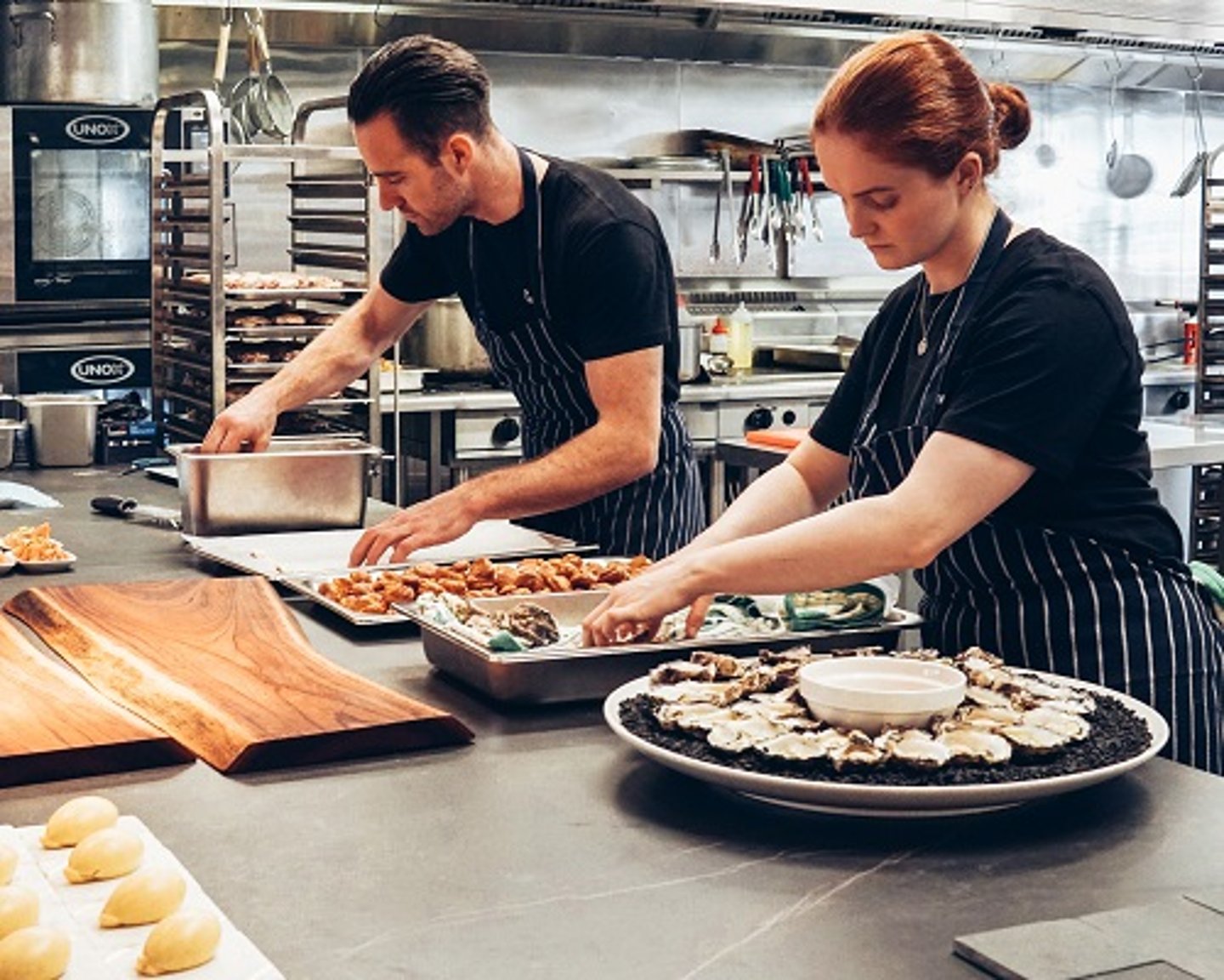 a group of people preparing food in a kitchen