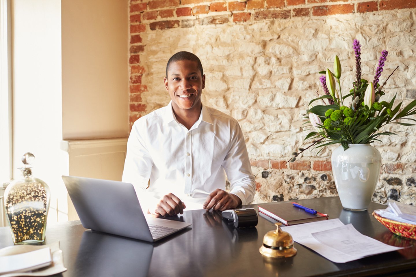 a person sitting at a table using a laptop