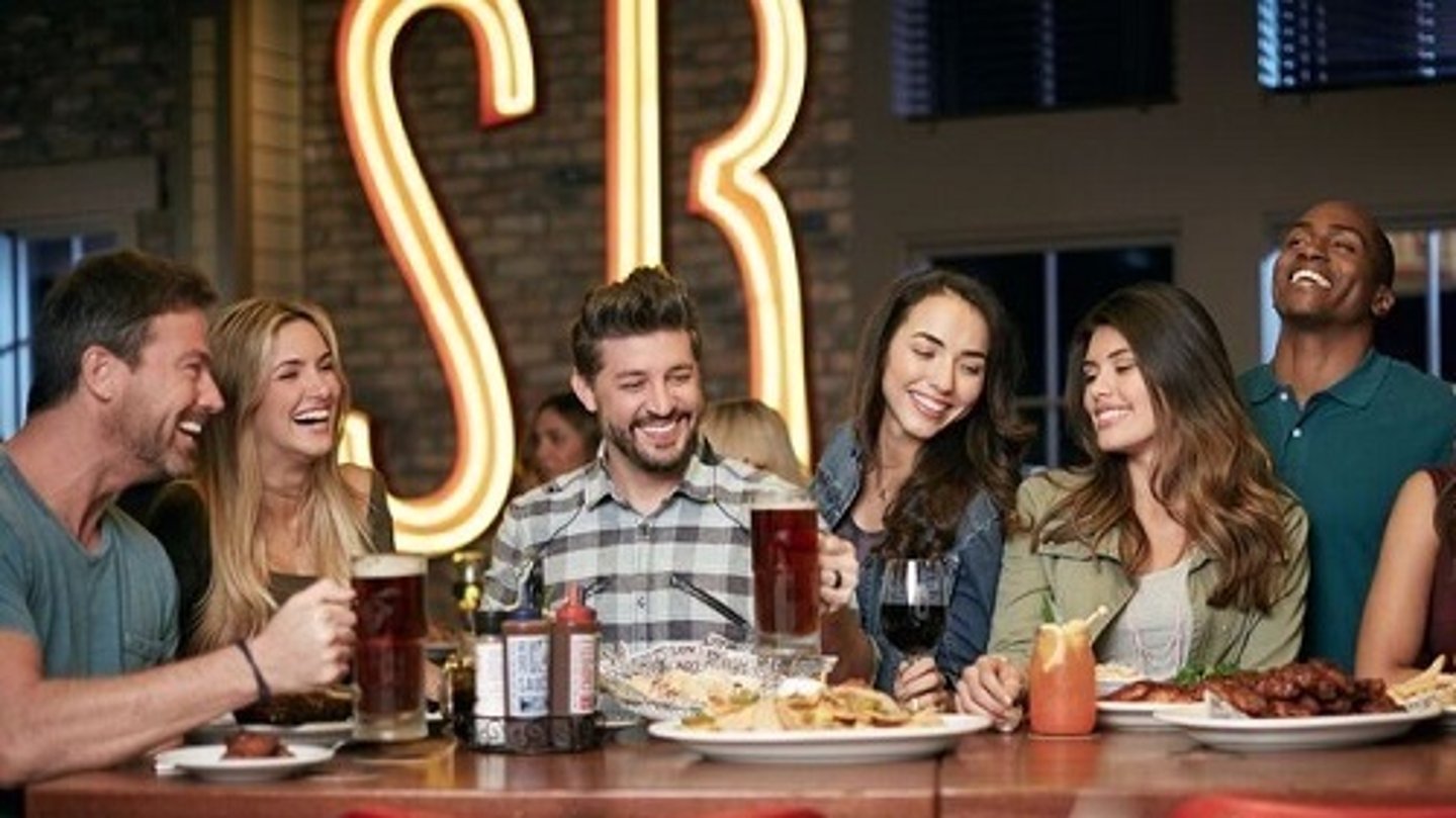 a group of people sitting at a table in a restaurant