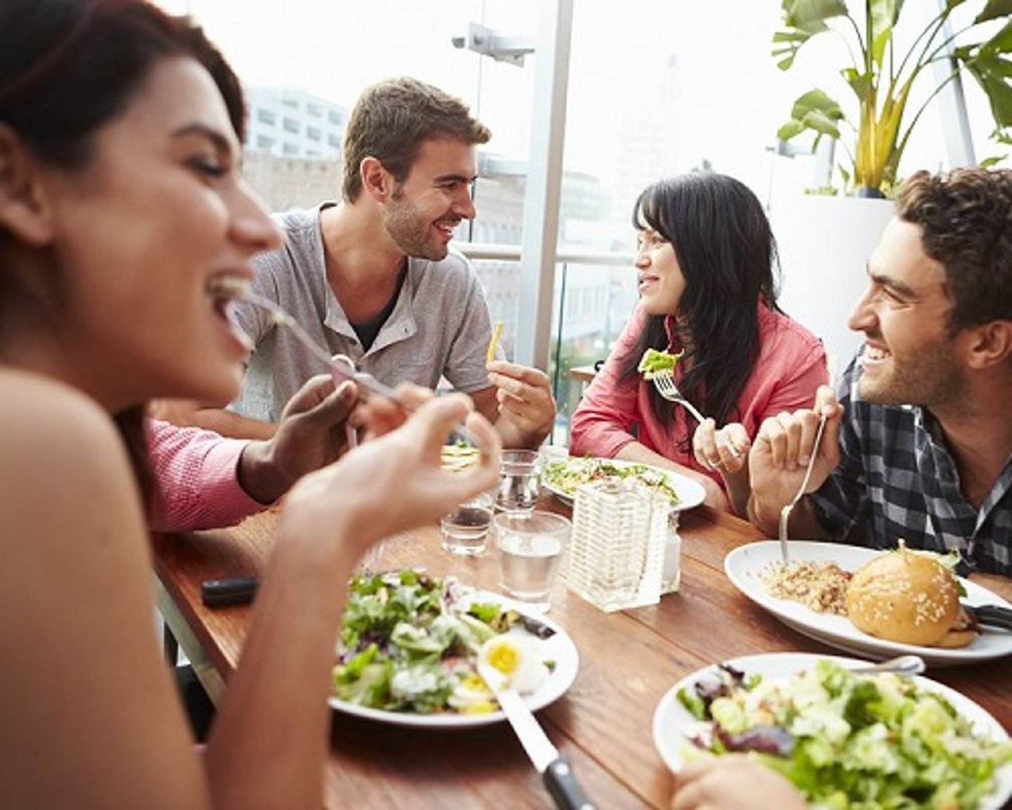 a group of people sitting at a table eating food