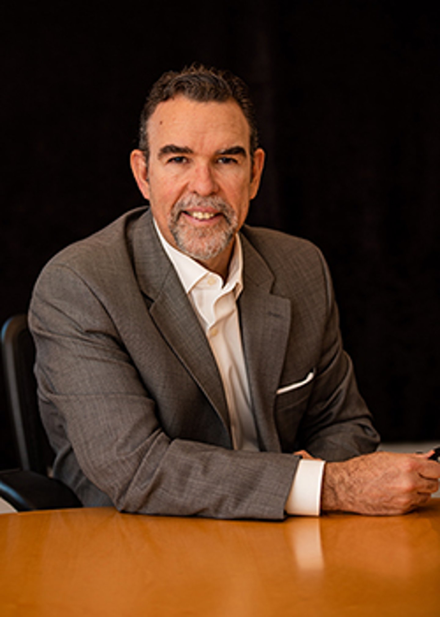 a man in a suit sitting at a table