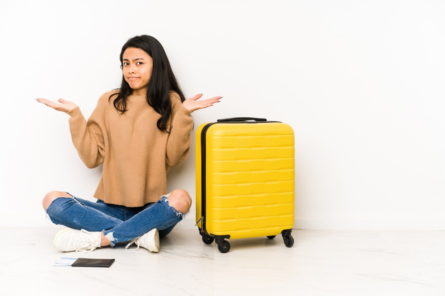 a woman sitting on a suitcase