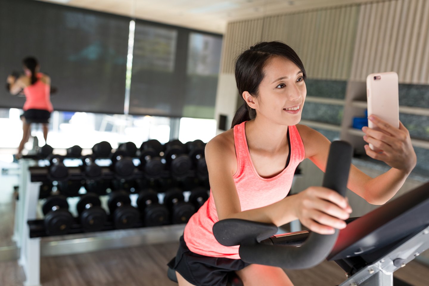 Women in hotel gym taking selfie