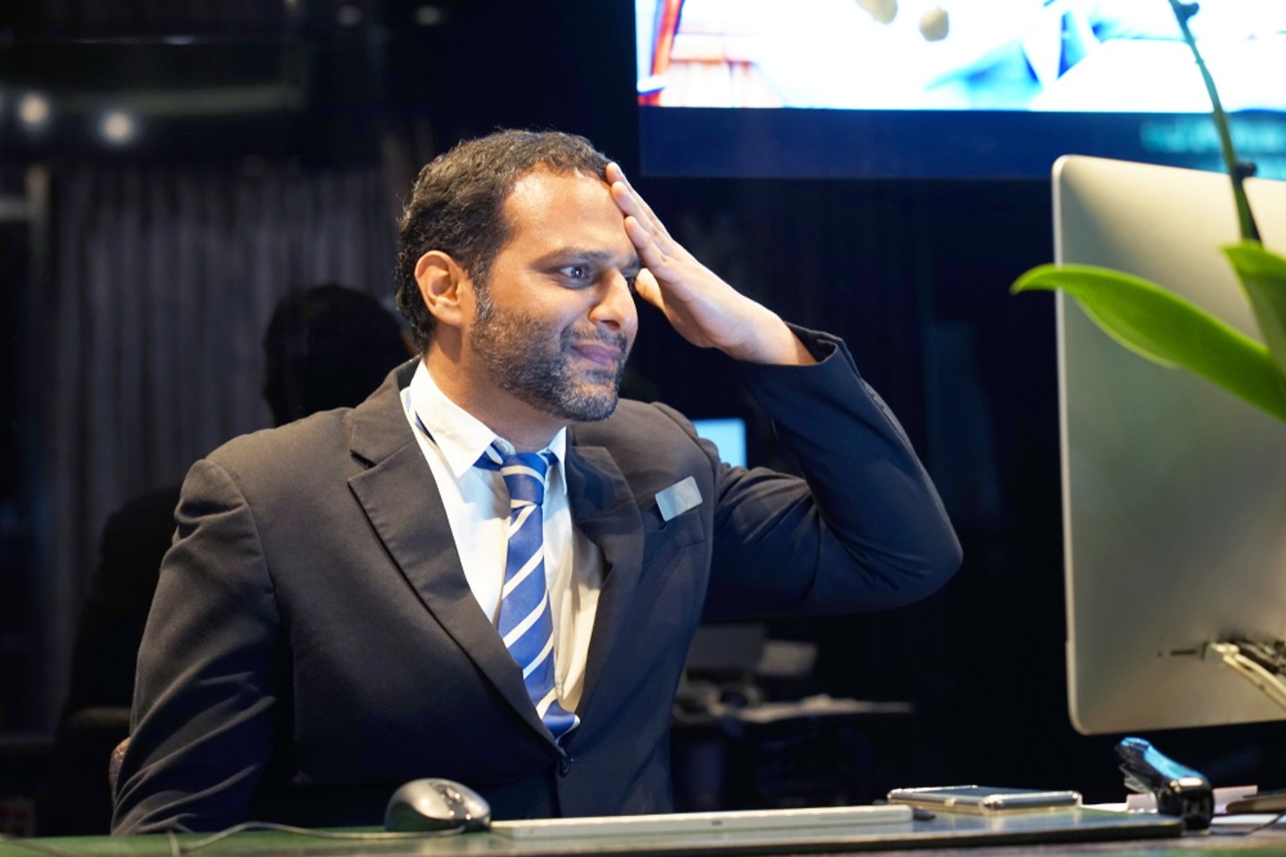 frustrated hotel manager in front of computer