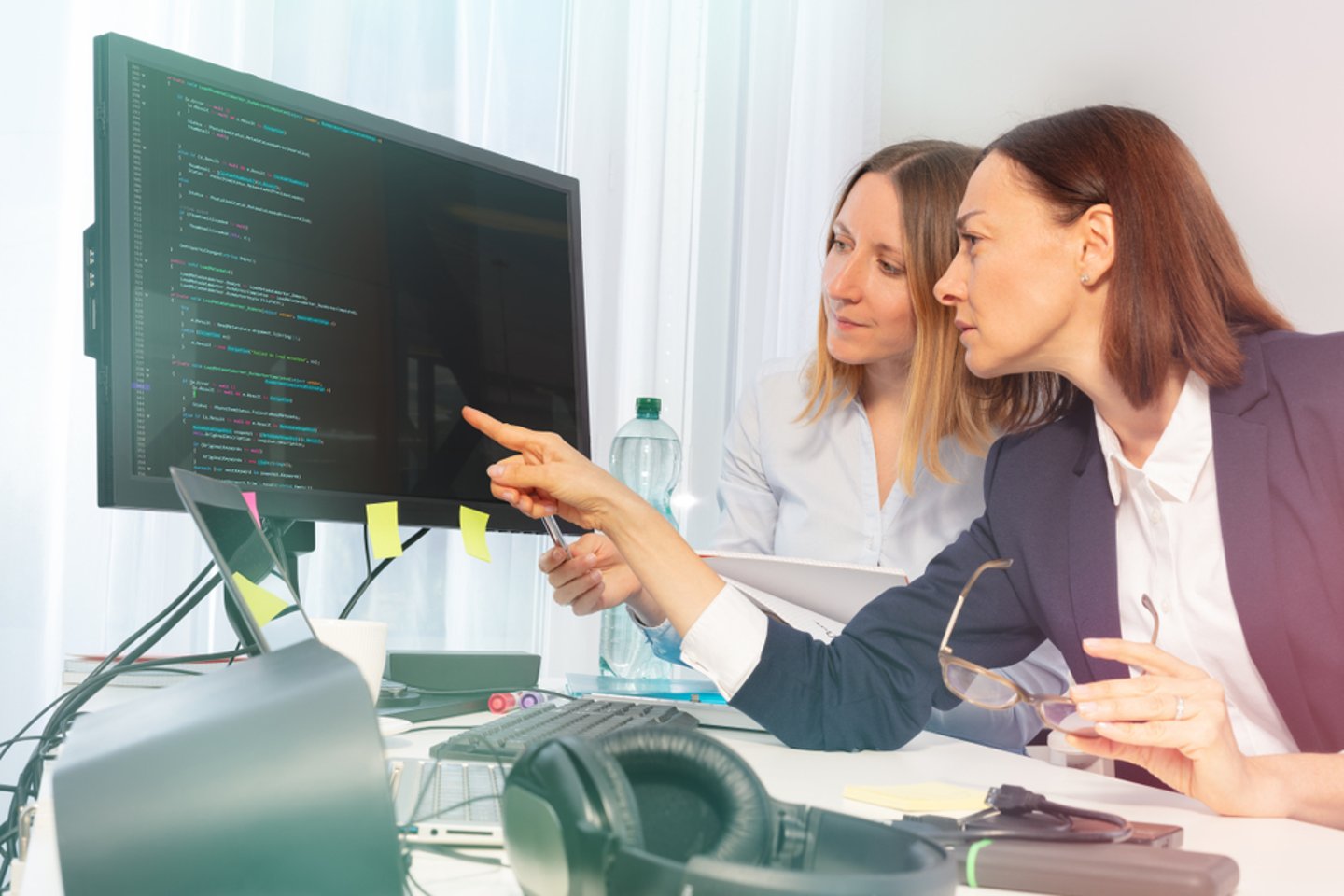 women looking at computer coding