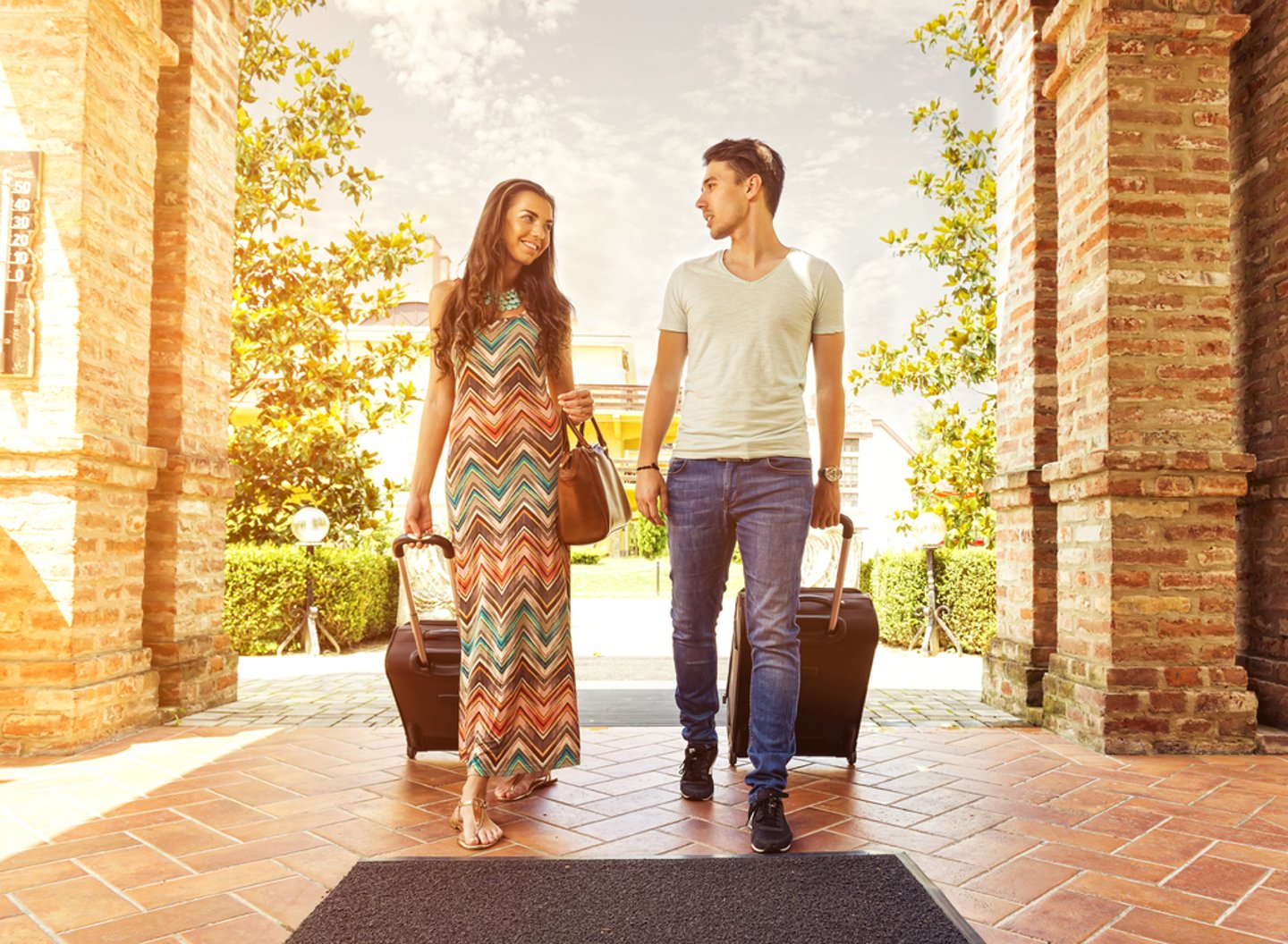 Travelers entering a hotel lobby