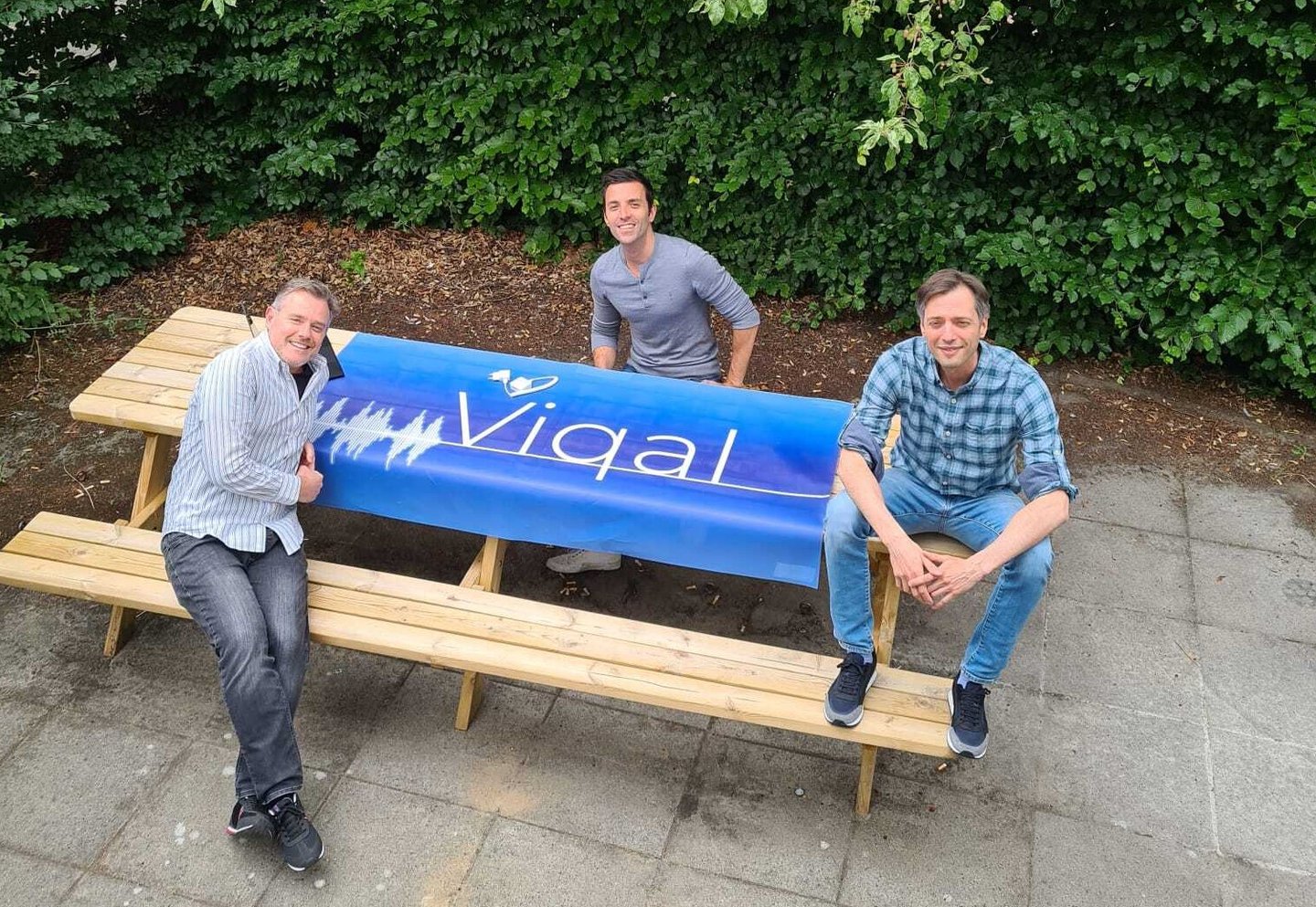 Viqal team members sitting on a bench