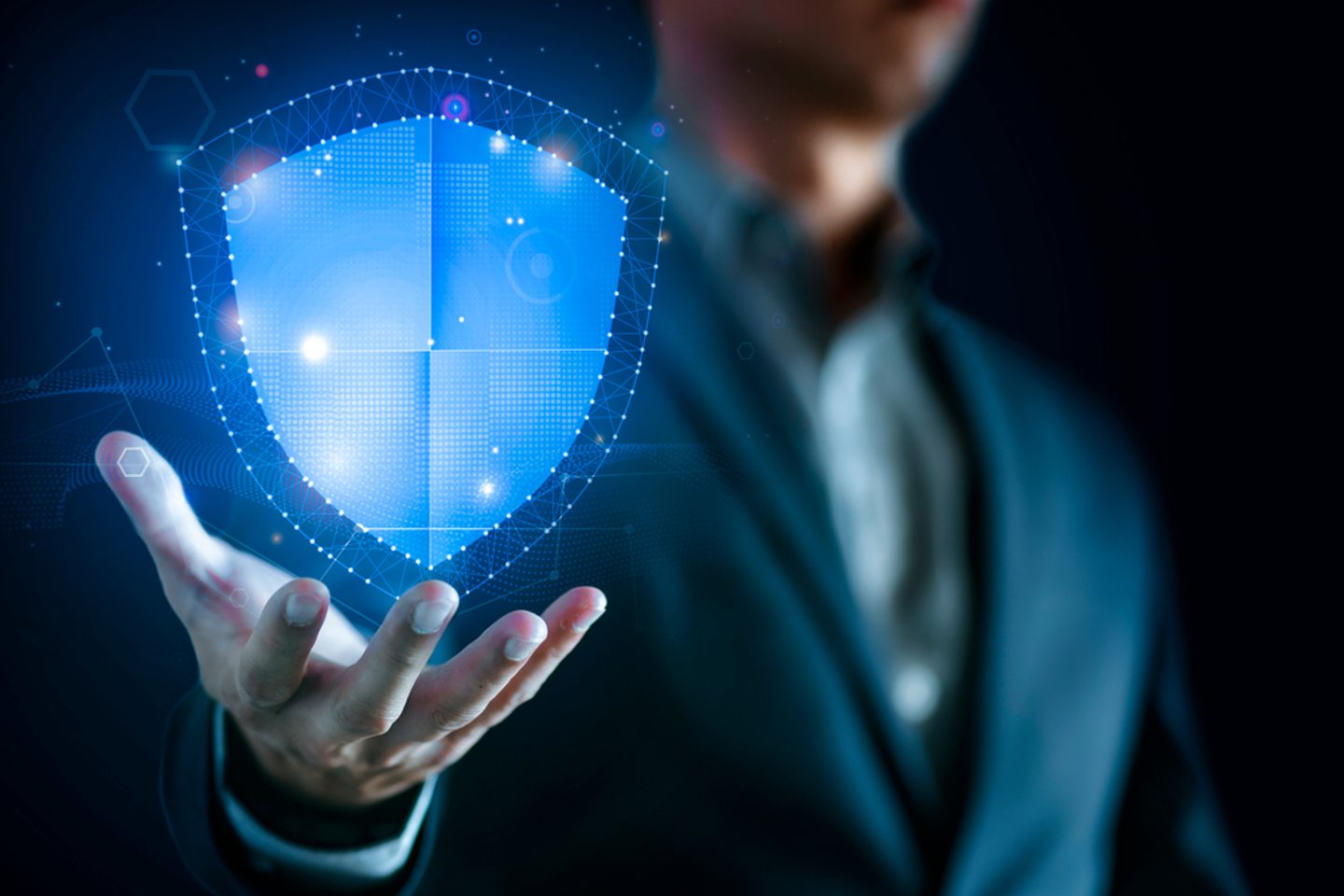 digital blue shield in front of a man in a suit