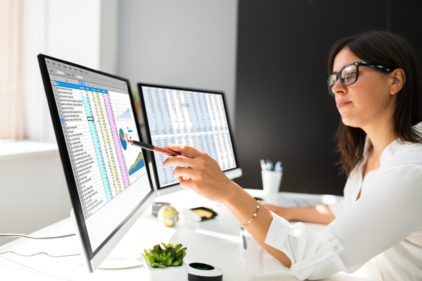 Woman looking at a spreadsheet on a computer screen