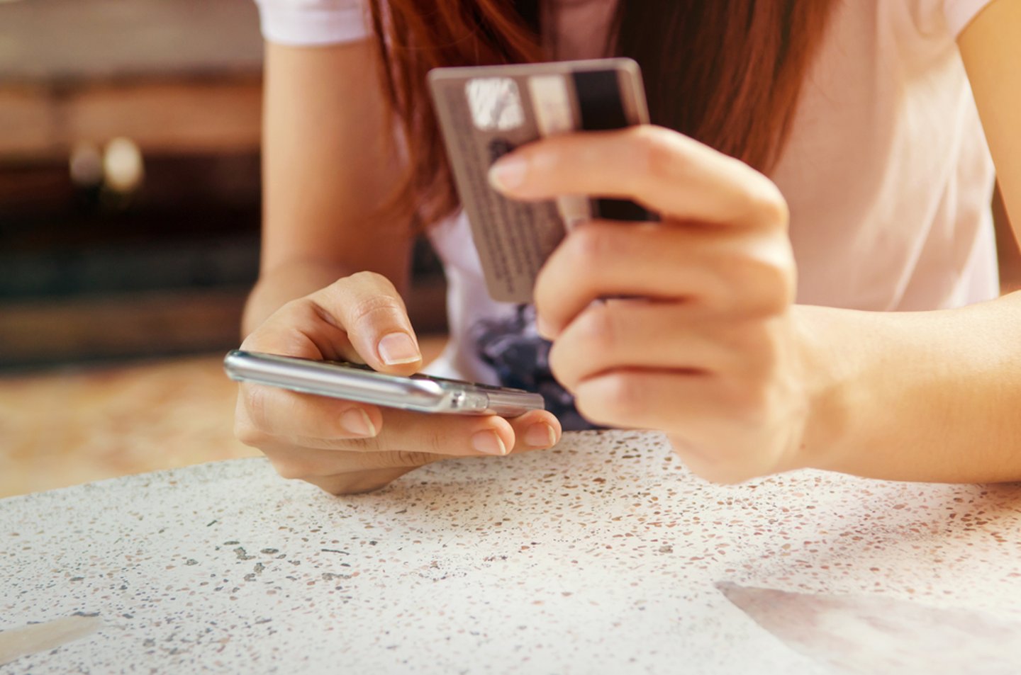 Woman holding a mobile phone and credit card