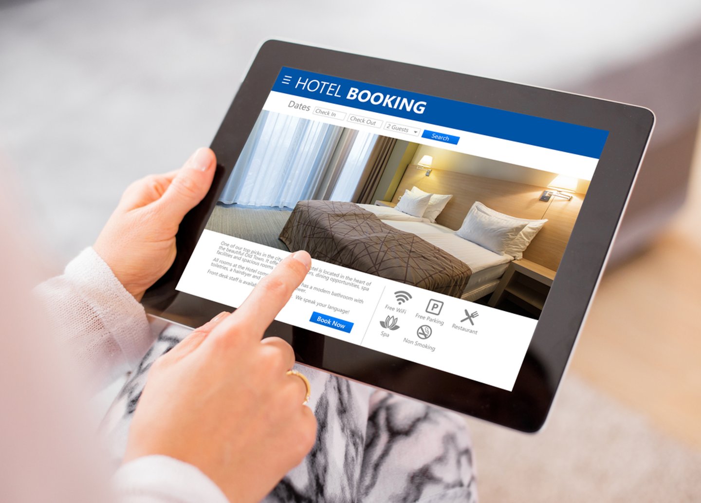 Person booking a hotel room via their tablet