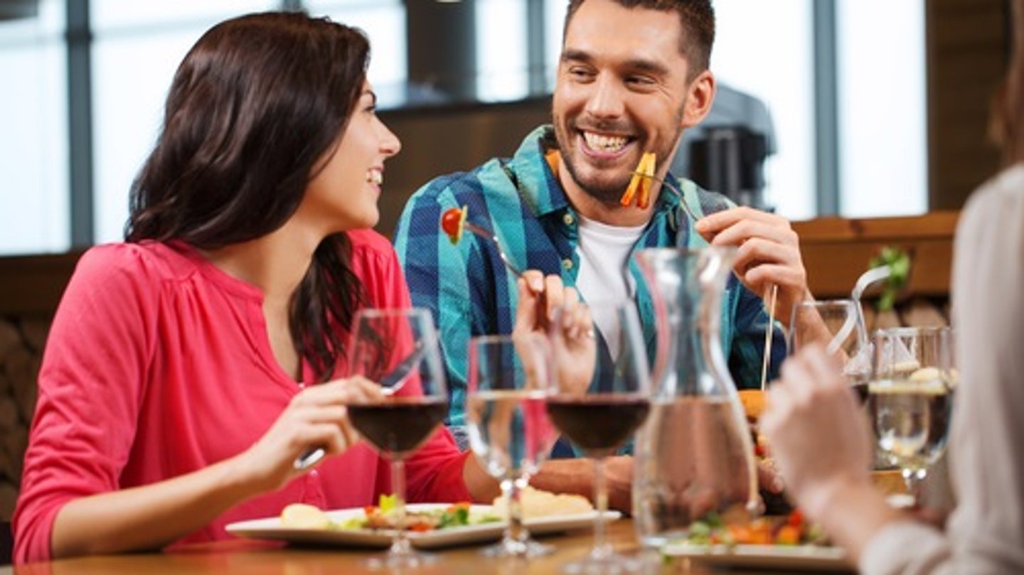 a group of people sitting at a table with wine glasses