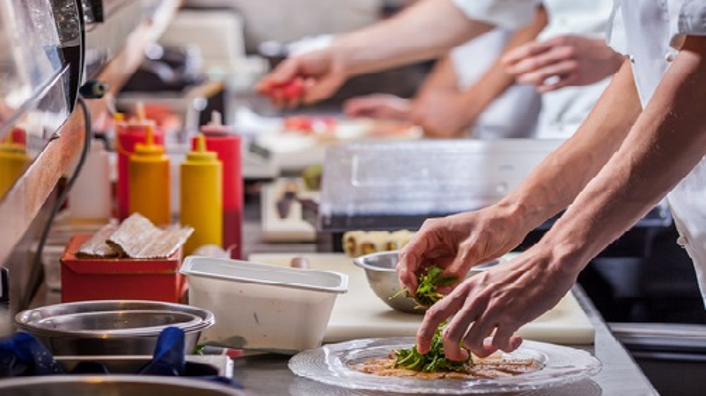 a person cooking in a kitchen preparing food