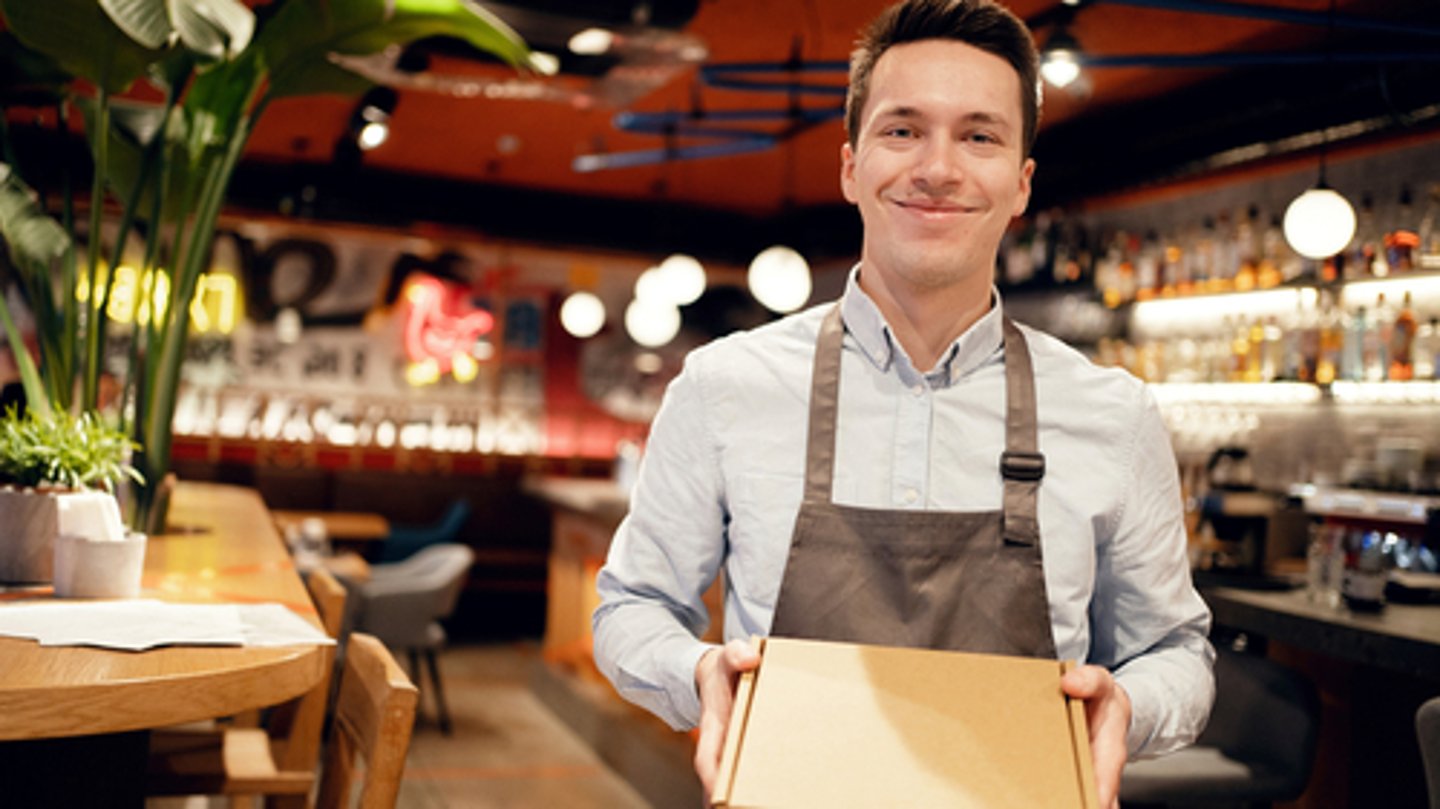 a person sitting at a table in a restaurant