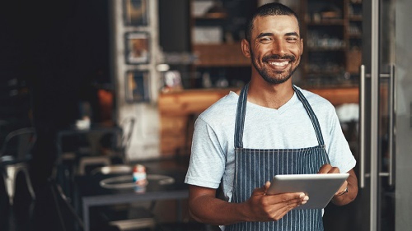 male restaurant owner staff with tablet