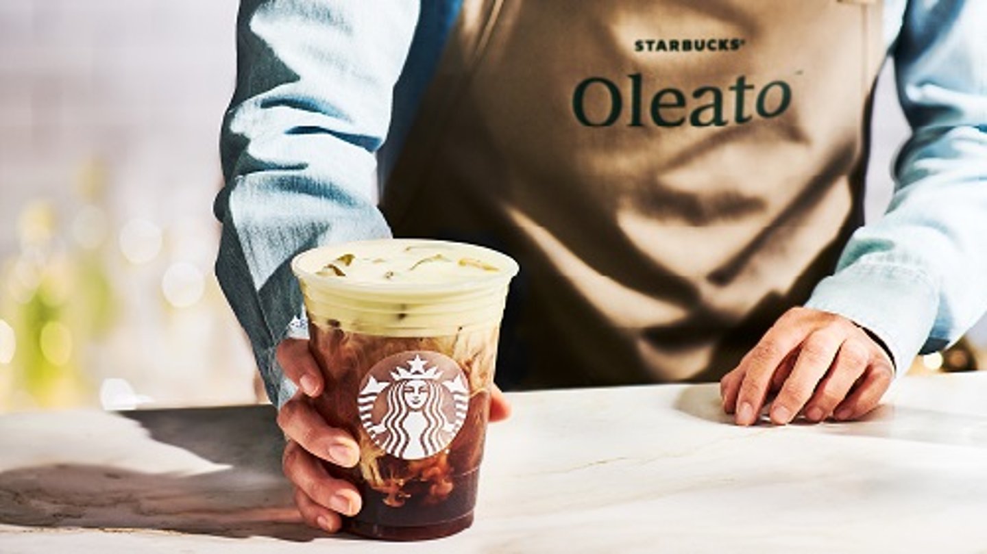 man placing Starbucks Oleato on the counter