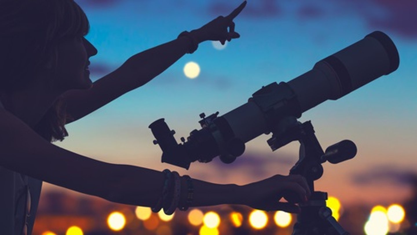 telescope in sky being used by man 