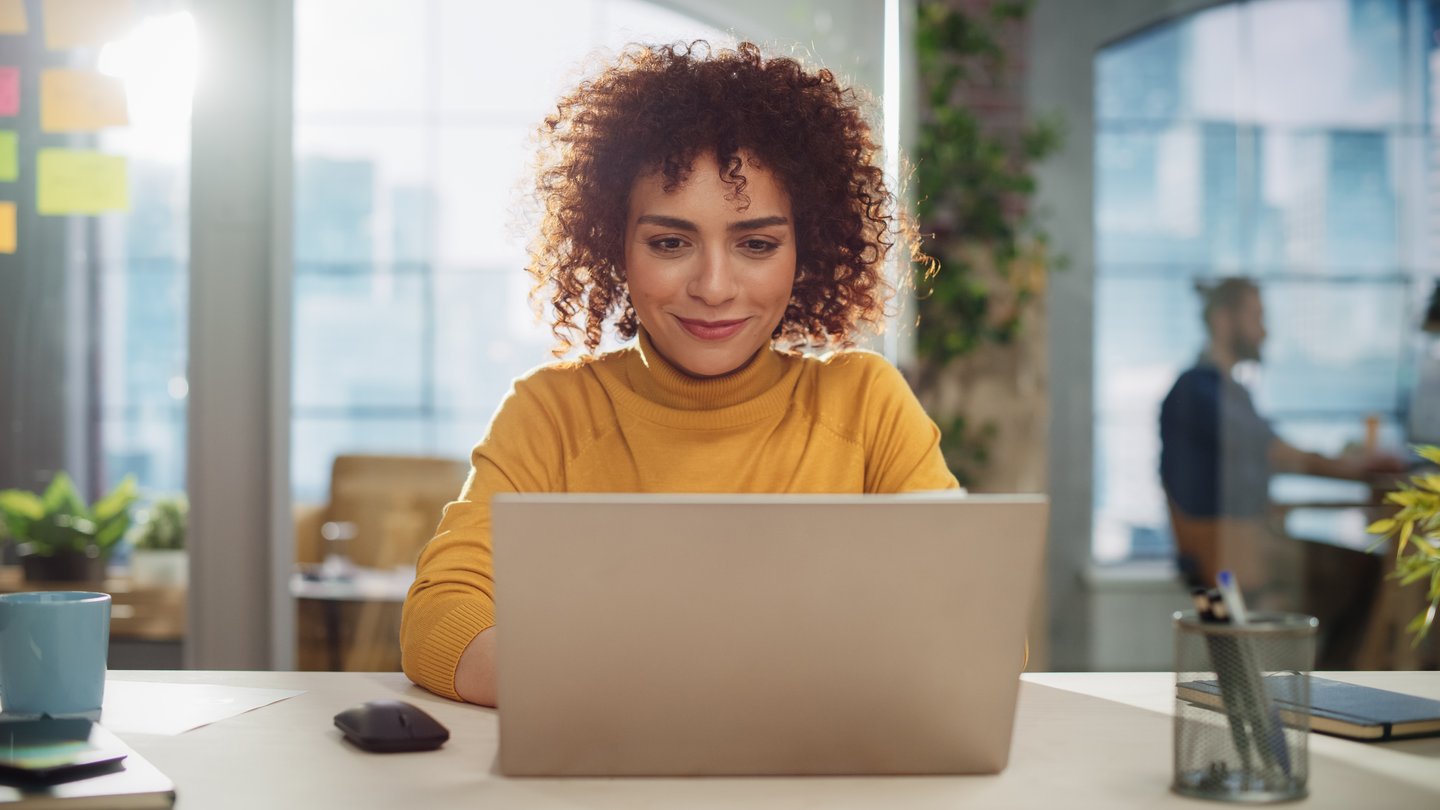 woman on laptop booking hotel stay