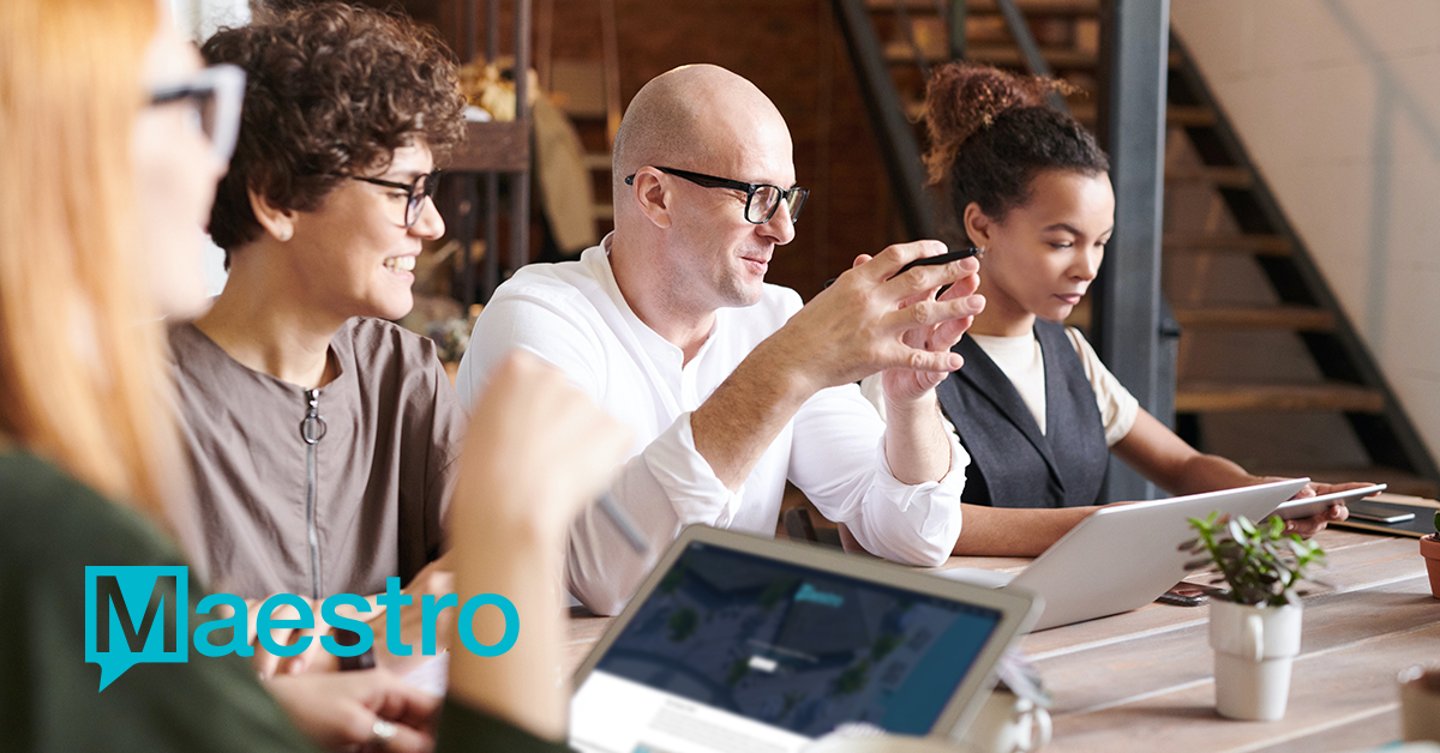 a group of people looking at laptops