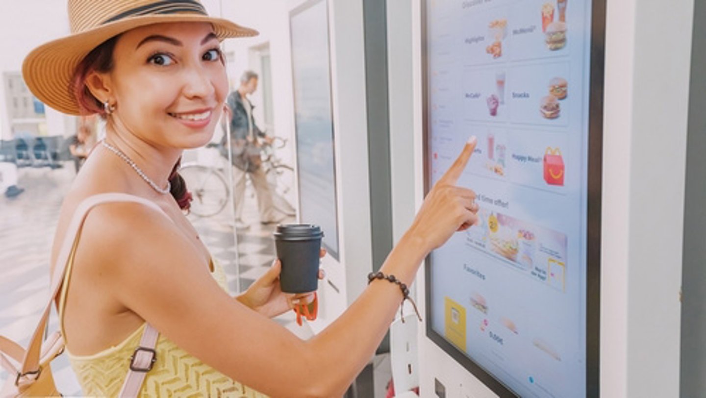 woman at a self service kiosk 