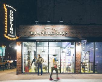 a group of people walking in front of a store