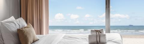 a large bed sitting next to a window