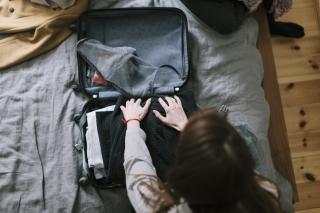 a bag of luggage sitting on top of a suitcase