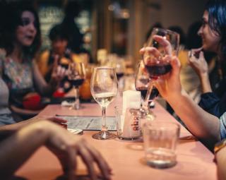a group of people sitting at a table with wine glasses