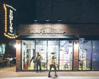a group of people walking in front of a store