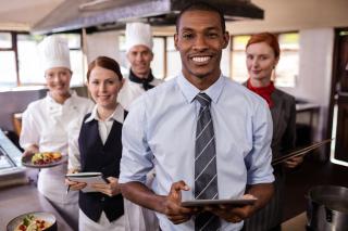 a group of people standing in a kitchen