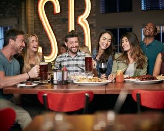 a group of people sitting at a table in a restaurant