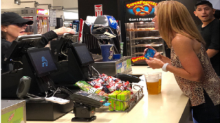 Blond woman pays at Appetize POS using contactless method