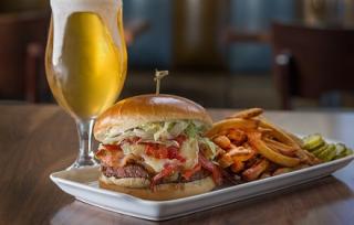 a plate of food and a glass of beer on a table